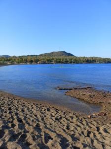 a beach with a body of water at Villetta Eoliana con piscina gratuita dall'11 Luglio al 31 Agosto in Vulcano