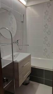 a bathroom with a shower and a sink and a tub at Lovely Apartment in Tauplitz
