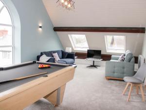 a living room with a pool table and chairs at Salem in Prestatyn