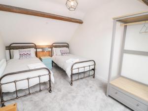 two beds in a room with a window at Salem in Prestatyn