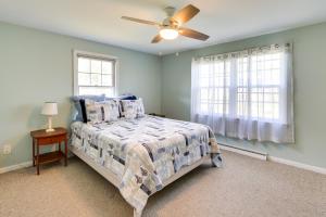 a bedroom with a bed and a ceiling fan at Charming Niantic Vacation Rental Walk to Beach! in Niantic