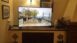 uma grande televisão de ecrã plano pendurada numa parede em Cortijo de Lorente Alojamiento Turístico Rural -Teba -Malaga em Teba