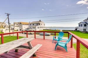 a deck with two chairs and a picnic table at Charming Niantic Vacation Rental Walk to Beach! in Niantic