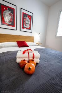 a bedroom with a bed with towels and pumpkins on it at Sikelia Apartments in Pozzallo
