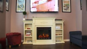 a fireplace in a living room with a tv above it at The Pink Fridge in Whitefish