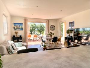 a living room with a couch and a table at Villa SYAGRUS - Easy Home Booking in Nice