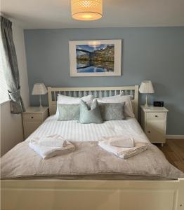 a bedroom with a bed with two towels on it at The Garden Apartment in Ironbridge
