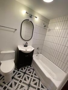 a bathroom with a toilet and a sink and a tub at The Spruce Lodge in South Fork