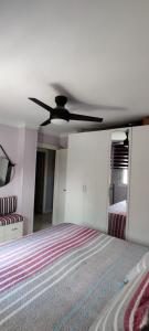 a bedroom with a bed and a ceiling fan at EL RINCON DORADO in Melilla
