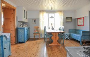 a living room with a table and blue furniture at Awesome Home In Årjäng With Sauna in Årjäng