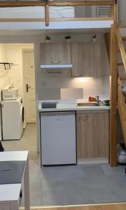 a kitchen with a counter and a white refrigerator at Side Street Apartments in Prague