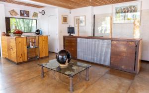 a living room with a table and a tv at Casa los Cantaros Hotel Boutique in Oaxaca City