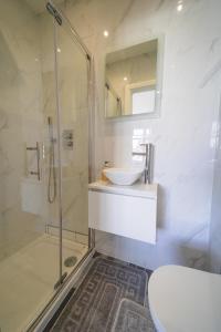 a bathroom with a sink and a shower and a toilet at Star London Bell Lane 3-Bed Haven in Hendon