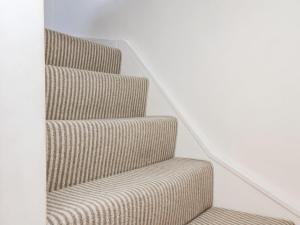 a set of stairs in a white room with a stair case at Navigators Rest in Whitby