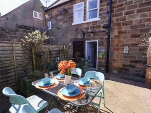 a table and chairs in the back yard of a house at Navigators Rest in Whitby