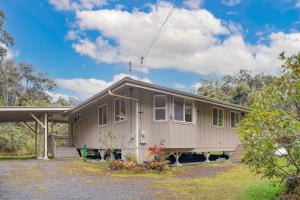 a small house with a porch on a lot at Hale Pau'ole in Volcano