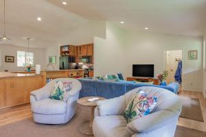 a living room with two chairs and a blue couch at Hale Pau'ole in Volcano