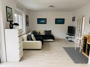 a living room with a couch and a tv at APARTMENT Schlossbergblick in Griffen