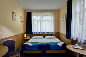 Postel nebo postele na pokoji v ubytování Jagelló Business Hotel