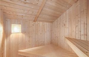a wooden room with a sauna with a window at Holiday Home Fanø 46 in Fanø +12 photos