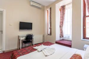 a hotel room with a bed and a desk at OttomanZade in Istanbul