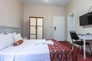 Un pat sau paturi într-o cameră la OttomanZade
