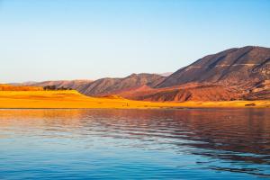 a view of a body of water with mountains in the background at Les Hortensias in Bine el Ouidane