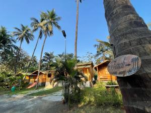 a view of a resort with palm trees at Casa de Kihim in Alibaug