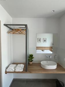 a bathroom with a sink and a mirror at SunBeam in Kardamaina