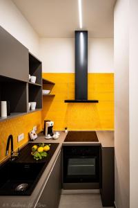 a kitchen with a sink and a stove top oven at Sikelia Apartments in Pozzallo