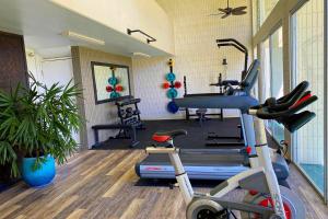 a gym with several exercise equipment in a room at Pat's at Punalu'u 304 in Laie