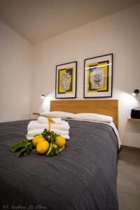 a bedroom with a bed with fruit on it at Sikelia Apartments in Pozzallo