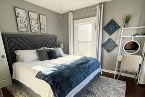 a bedroom with a large bed and a window at 1908 Modern Farmhouse on large private treed lot in Shawnee