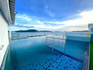 a swimming pool with a view of the water at Casa Le Oasis (13A) in Kuah