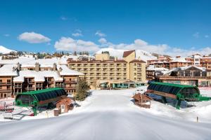 a resort in the snow with snow covered buildings at Elevation Hotel & Spa in Mount Crested Butte