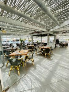 a dining area with tables and chairs in a building at Sunset Beach Benalmadena in Benalmádena