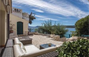 an outdoor patio with a couch and a view of the water at Stunning Home In Klek With Sauna in Klek