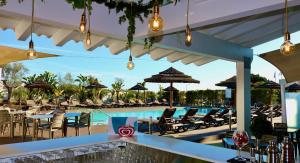 a resort with a pool and chairs and a bar at Lagos Atlantic Hotel in Lagos