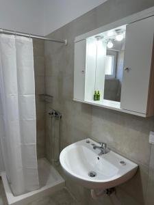 a bathroom with a sink and a shower with a mirror at Anna Holiday House, eco-friendly! in Kría Vrísi +19 photos