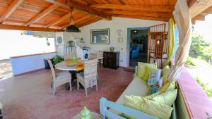 a living room with a couch and a table at Casa Vacanze Giada in Oliena