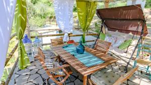 a table and chairs sitting on a patio at Casa Vacanze Giada in Oliena +32 photos