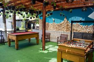 a room with a pool table and a ping pong table at Pousada SUN Victory in Cabo Frio