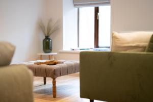 a living room with a couch and a ottoman at Spacious Property with Waterfall View by LetMeStay in Ambleside