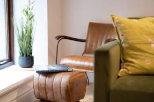 a remote control sitting on a ottoman in a living room at Spacious Property with Waterfall View by LetMeStay in Ambleside