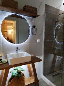 a bathroom with a sink and a mirror at Coritos apartments 2 Corfu in Kontokali