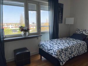 a bedroom with a bed and a window with a view at Twayi Luxury Suites in Jönköping