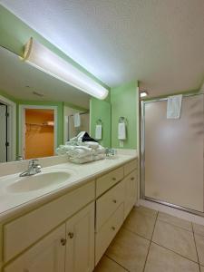 a bathroom with a large sink and a shower at Treasure Island 2202 in Panama City Beach
