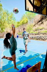 a group of people playing a game of basketball on a court at Cabaña La Casona de Ripaluna in Paihuano