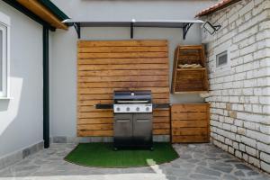 a outdoor kitchen with a stove in a garage at Kritamos Luxury Apartment in Chrysi Ammoudia