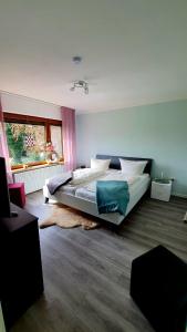 a bedroom with a large bed with a rug at Ferienhaus Siebrands in Greetsiel